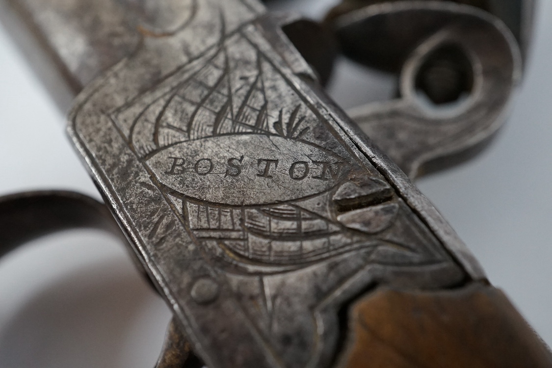 A boxlock flintlock pocket pistol with turn off barrel, Birmingham proof, frame engraved with flag trophy and foliage signed Boston within oval, sliding top thumb safety, slab walnut grip. Condition - fair to good.